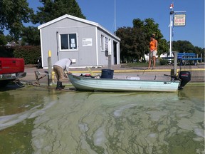 A fisherman removes his boat from Lake Erie at the boat ramp at Colchester Harbour which was invaded by blue-green algae on Sept. 26, 2017.