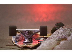 A skateboard lays next to a curb near the corner of Ouellette Avenue and Riverside Drive as Windsor police investigate a serious accident involving a skateboarder and an SUV on Monday, Sept. 25, 2017.