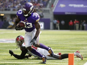 Minnesota Vikings running back Dalvin Cook runs from Tampa Bay Buccaneers cornerback Vernon Hargreaves, rear, during the first half of an NFL football game, Sept. 24, 2017, in Minneapolis.