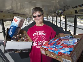 Nicole Dechevigny-Vickers collects food supplies in her school bus outside No Frills in East Windsor, Saturday, Sept. 9, 2017.  Vickers is donating the food to Drouillard Place.