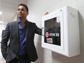 Frank Cremasco stands in the hallway of St. Thomas of Villanova school with a defibrillator he donated in memory of his father who died from cardiac arrest in June 2016. Cremasco donated 37 defibrillators to be installed in public places, including 17 to the Greater Essex County District School Board and 10 to the Windsor-Essex Catholic District School Board.