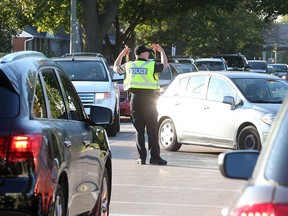 A Windsor police officer directs heavy traffic at Northwood Street and Dominion Boulevard on Sept. 6, 2017.
