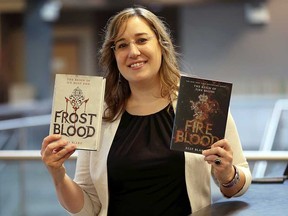 Harrow-based writer Elly Blake holds up copies of Frostblood and its sequel Fireblood - two books of her ongoing magical fantasy saga for young adults, published by Little, Brown and Co.