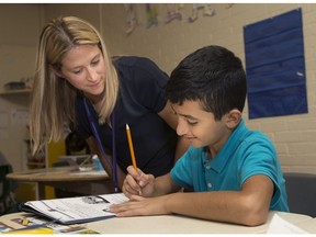 Sara Johnston-Pye, an ESL teacher at Prince Edward school in Windsor, instructs Hassan Mohammad, 11, during class on Sept. 28, 2017.
