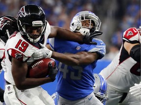 Atlanta Falcons wide receiver Andre Roberts  stiff-arms Detroit Lions defensive back Charles Washington during the second half of an NFL game on Sept. 24, 2017, in Detroit.