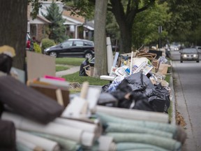 Damaged items are placed in large piles on the curb in the 2300 block of Turner Road, Saturday, Sept. 2, 2017.