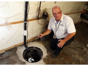 City of Windsor building inspector Dwayne Kenney checks a home sump pump in Windsor on Sept. 20, 2017.