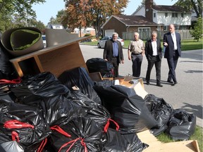 Essex County Warden Tom Bain, left, Essex Mayor Ron McDermott, Ontario Municipal Affairs Minister Bill Mauro and Windsor Mayor Drew Dilkens tour flood damage on Kildare Road in South Walkerville on Sept. 12, 2017 in Windsor.