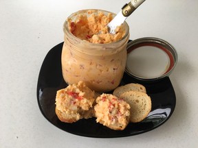 This 2017 photo shows Classic Pimento Cheese from a recipe by Elizabeth Karmel, in Houston, Texas. This comfort food is basically only three simple ingredients, sharp cheddar cheese, jarred pimentos and mayonnaise - but when you combine them, you get a creamy, sharp, piquant spread that is so versatile you can use it for just about any meal part.