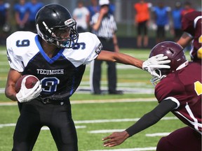 Jayden West, left, of Tecumseh Vista Academy slips by Xavier Leonard of Leamington District Secondary School during high school football action in Tecumseh on Sept. 14, 2017. Vista won 41-0.