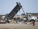 Garbage from flooded homes starts to build up at the former GM plant between Kildare Road and Walker Road on Sept. 10, 2017. 