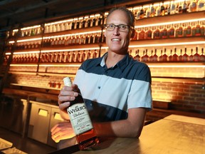 Hiram Walker and Sons distillery's master blender Don Livermore is shown with a bottle of J.P. Wiser Whisky, the company's flagship product, in September 2016.