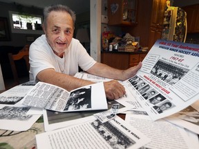 Joe Bocchini displays an anniversary poster and old photos from the early days of the Windsor Minor Hockey Association at his Windsor home Tuesday. Bocchini was among a group of local men who helped expand the league for younger players 50 years ago.