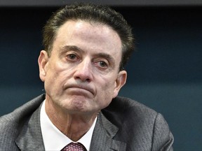 In this Oct. 20, 2016, file photo, Louisville coach Rick Pitino reacts to a question during an NCAA college basketball press conference in Louisville, Ky. The NCAA suspended Pitino, in June for five ACC games following sex scandal investigation. On Wednesday, the university fired him because of new scandal that came to light this week.
