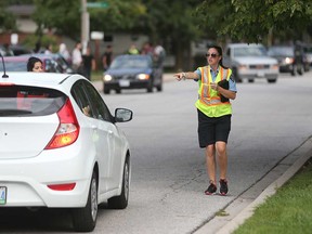 A City of Windsor parking enforcement officer gestures at an illegally stopped vehicle at Vincent Massey Secondary School in this September 2016 file photo.