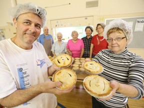 Bedford United Church parishioners Bob Nagy, front left, and Eileen Trothen display meat pies baked Tuesday for this Sunday’s Open Street event starting at noon at Patterson Park and West Side Foods on Sandwich Street. Looking on are Larry Skinner, back left, Mary Chaif, Helen Davis, Shin MacDonald, and Darlene Morency. Volunteers at the Sandwich Street church also bake and sell the pies at the Farmers Market at the old Forster high school on Saturdays from 9 a.m. to 3 p.m. until the market closes down for the season.