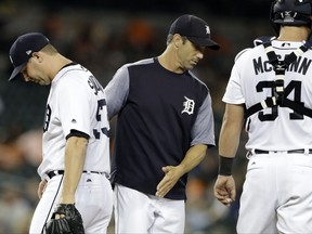 Detroit Tigers manager Brad Ausmus pulls relief pitcher Warwick Saupold during the fifth inning of a baseball game against the Minnesota Twins, Thursday, Sept. 21, 2017, in Detroit. (AP Photo/Carlos Osorio)