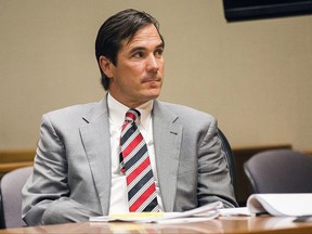 FILE - In this Aug, 10, 2017, file photo, Nick Lyon, director of the Michigan Department of Health and Human Services, appears in Genesee County District Court in Flint, Mich. Lyon, who is blamed in the death of a Flint-area man who had Legionnaires' disease faces a key hearing starting Thursday, Sept. 21, 2017, to determine whether he will stand trial for involuntary manslaughter. He's accused of failing to alert the public in a timely manner about a Legionnaires' outbreak in the Flint area in 2014-15. (Terray Sylvester/The Flint Journal-MLive.com via AP, File)