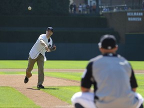 Lobbyist Matt Mika throws a ceremonial pitch to Detroit TIgers' Tyler Collins before a baseball game against the Minnesota Twins, Sunday, Sept. 24, 2017, in Detroit. Mika was shot in the chest and arm during a practice for a congressional baseball game on June 14. (AP Photo/Jose Juarez)