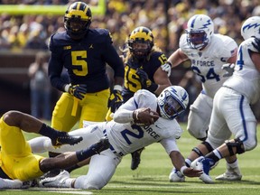 Air Force quarterback Arion Worthman (2) stretches for extra yards on a carry in the first quarter of an NCAA college football game against Michigan in Ann Arbor, Mich., Saturday, Sept. 16, 2017. (AP Photo/Tony Ding)