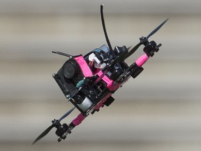 A drone flies the course during a race at the Montreal drone expo, Saturday, June 25, 2016.