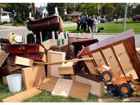 Garbage from the recent flooding is seen as Provincial NDP leader Andrea Horwath along  MPP  Lisa Gretzky, MPP Percy Hatfield, Windsor mayor Drew Dilkens, and MPP Taras Natyshak speak with Windsor homeowners who were hit with the recent flood in Riverside on Sept. 7, 2017.