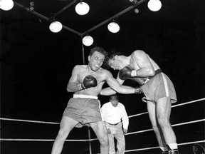 In this June 16, 1949, file photo, Jake LaMotta, left, pounds Marcel Cerdan in third round of a world middleweight title bout in Detroit, Mich. LaMotta won the title by a knockout in the 10th round. LaMotta, whose life was depicted in the film Raging Bull, died Sept. 19, 2017, at a Miami-area hospital from complications of pneumonia. He was 95.