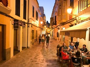 This June 16, 2017 photo shows dining and walking in Ciutadella on Menorca, Spain. The city was the island's fortified capital until Turks sacked it and the British moved the capital across the island to Mahon.