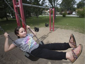Tasneem Mughrabi, 9, swings in the playground of Polonia Park, Sunday, Sept. 3, 2017.