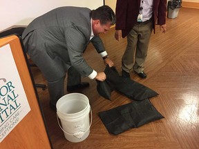 Windsor Regional Hospital president and CEO David Musyj demonstrates the use of Quick Dam flood barrier bags on Sept. 8, 2017. The hospital has purchased at least $4,000 worth of the bags after the Met Campus had to be closed due to flooding during the record-breaking storm of Sept. 5.
