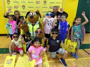 Students from Notre Dame Catholic Elementary School in Windsor pose with Safety Dog during the Safety Dog Bus Tour along with First Student, the bus transportation provider for Windsor-Essex students.The Safety Dog Bus Tour allows students to participate in interactive safety lessons, get their photo taken with the Safety Dog mascot, sign a pledge of safety and head home with a bag of treats.