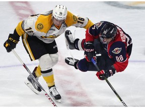 Jordan Ernst, left, of the Sarnia Sting and Kirill Kozhevnikov of the Windsor Spitfires collide during their exhibition game on Sept. 15, 2017, at the WFCU Centre in Windsor. Spits won 5-2.