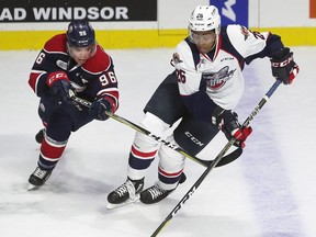 Damien Giroux, left, of the Saginaw Spirit and Cole Purboo of the Windsor Spitfires battle for the puck.