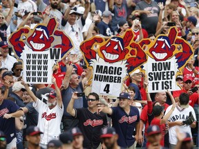 Cleveland Indians fans celebrate a 5-3 victory over the Detroit Tigers in a baseball game, Sept. 13, 2017, in Cleveland. The Indians set the American League record with 21 consecutive wins.