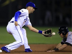 Kansas City Royals second baseman Whit Merrifield, left, tags out Detroit Tigers' Ian Kinsler, right, during the sixth inning of a baseball game at Kauffman Stadium in Kansas City, Mo., Sept. 26, 2017.