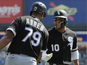 Chicago White Sox second baseman Yoan Moncada (10) is congratulated by first baseman Jose Abreu (79) after hitting a home run against the Detroit Tigers in the first inning of a baseball game on Sept. 14, 2017, in Detroit.