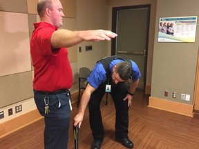 A Windsor Regional Hospital security guard demonstrates metal detector 'wanding' with a fellow security staff member on Sept. 8, 2017.