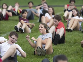 Students from Brennan Catholic High School and Corpus Christi Catholic Middle School exercise Wednesday. The event was funded by an OFSAA Try Day grant and led by Mehari Hagos, a Catholic Central grad who now runs a program to  promote healthy active living for inner city kids.