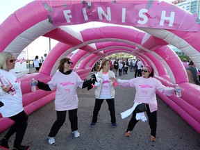 Catholic Teachers team members Jen Bonofiglio, left, Jackie Iannucci, Maria Liolli and Teresa Campanaro, right, limber up before participating in the CIBC Run for the Cure in support of breast cancer research at Windsor's Riverfront Festival Plaza Sunday morning, Oct. 1, 2017.