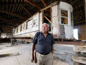 Local businessman George Sofos poses on Aug. 10, 2017, with streetcar No. 351 which once operated on the local streets. City council has approved a plan to restore the 99-year-old trolley.