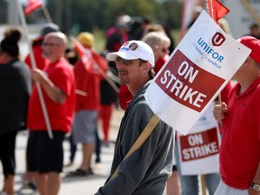 Picketers walk the line outside the strikebound Cami car factory in Ingersoll on Thursday, as the focus in the 11-day strike by 2,800 workers shifted to getting top executives in General Motors in Detroit involved in the stalemate. Cami is operated by GM Canada.