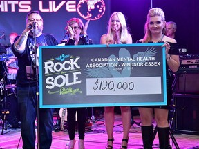 From left: MC Greg Gynp, Canadian Mental Health Association CEO Claudia den Boer, CEO, CMHA-WECB, Rock Your Sole organizer Jasmine Jasey and Kim Willis celebrate a record-breaking fundraising event Friday at the Water's Edge Event Centre.