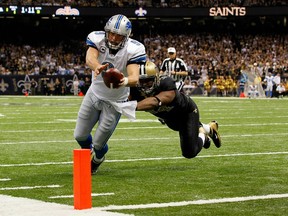 Detroit's Matthew Stafford dives for the touchdown against Will Smith of New Orleans during their 2012 NFC Wild Card Playoff game at Mercedes-Benz Superdome on Jan. 7, 2012 in New Orleans.