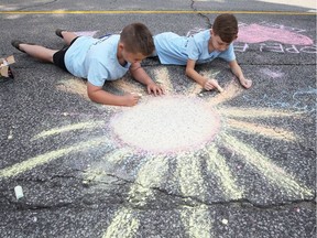 Jack Lovell, 11, left, and Adrian Fitzsimmons, 12, have a great time during Open Streets Windsor on University Avenue West on September 17, 2017.