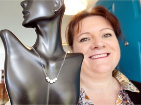 Jewelry designer Sandra Cooze, shown here Oct. 20, 2017, holds her necklace which was used by an actress on an episode of the television series Arrow.