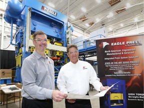 Eagle Press & Equipment Co. Ltd. controller Mark Polewski, left, and president Ted Polewski are shown with the 800-ton Servo Press, the first of its kind to be built in Canada.