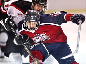 In this 2005 file photo, Windsor Junior Spitfires bantam major Jordan Shaw battles with Tecumseh Eagles Luc Hartman in the third period at the Riverside Hockey Bantam Tournament at Riverside Arena.