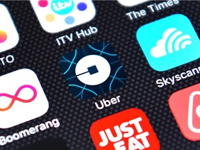The Uber app logo is displayed on an iPhone on August 3, 2016 in London, England.