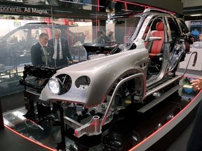 Visitors look to a car model with components of the auto parts manufacturer 'Magna' at the 2017 Frankfurt Auto Show 'Internationale Automobil Ausstellung' (IAA) on September 13, 2017 in Frankfurt am Main, Germany.