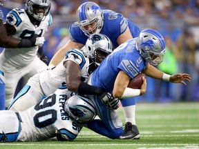 Detroit quarterback Matthew Stafford is sacked by Carolina defensive end Julius Peppers during the second half at Ford Field on Oct. 8, 2017 in Detroit.